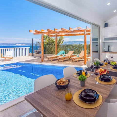 Serve up sumptuous homemade meals in the poolside summer kitchen