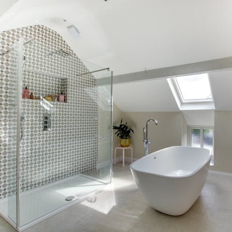 Live like royalty with a huge walk-in shower and freestanding tub all to yourselves