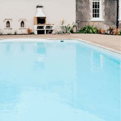 Take a dip in the enormous outdoor swimming pool 