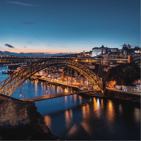 Admire the stunning D. Luís I Bridge at night, a five-minute walk away