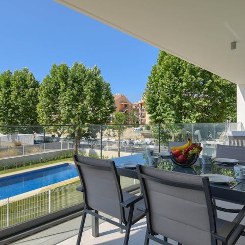Enjoy an alfresco breakfast on the balcony overlooking the pool