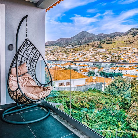 Bag the hanging egg chair and take in the view of Machico sprawling before you