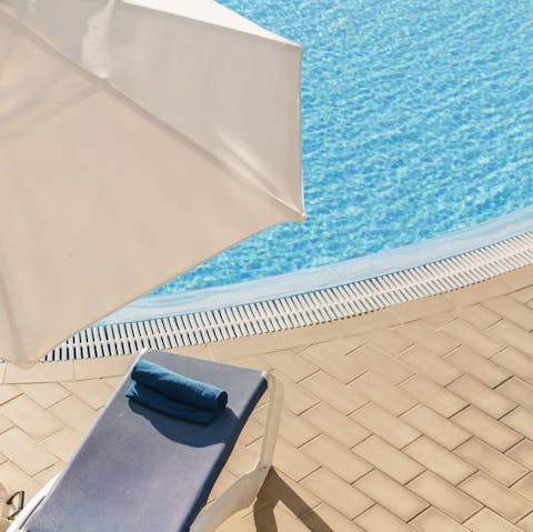 Spend lazy days lounging by the communal pool