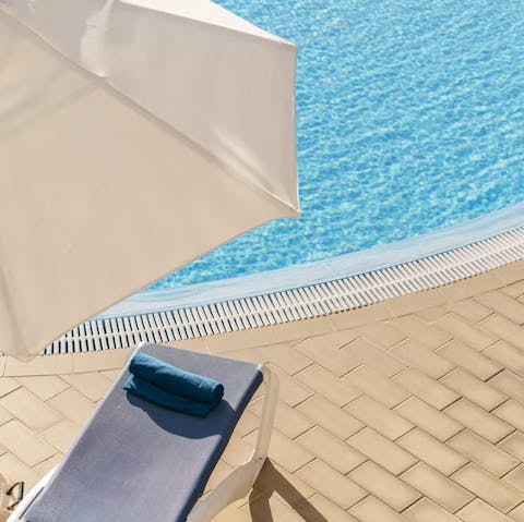 Spend lazy days lounging by the communal pool