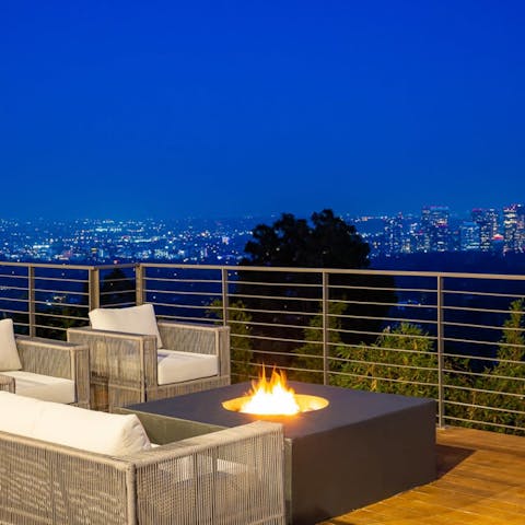 Watch the lights of LA twinkle in the dark as you relax with a drink by the fire pit