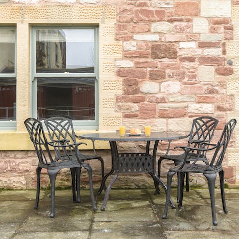 Enjoy your morning coffee on the home's terrace in the front garden