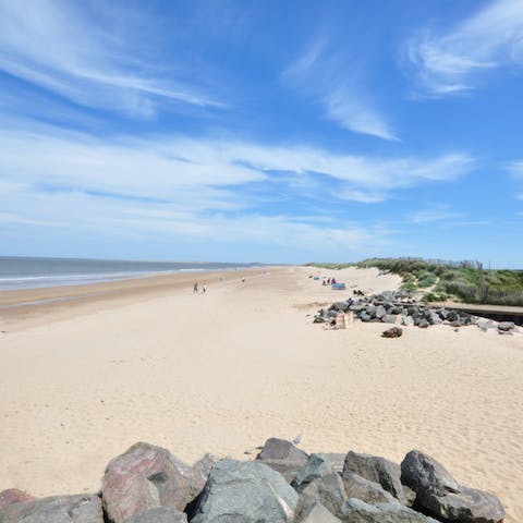 Stroll along the soft sands of Brancaster Beach,  a short car ride away