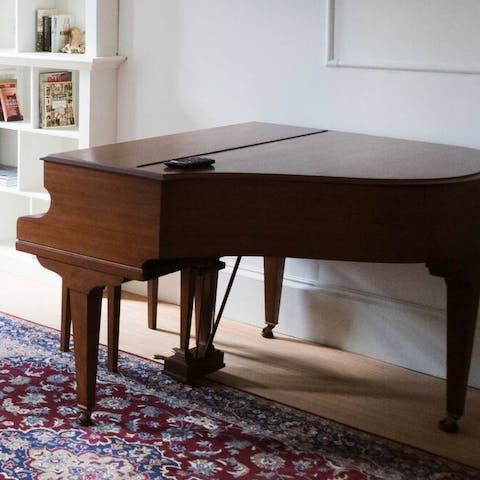 Tickle the ivories on the apartment's grand piano