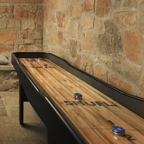 Challenge your loved ones to a game of shuffle board in the cellar