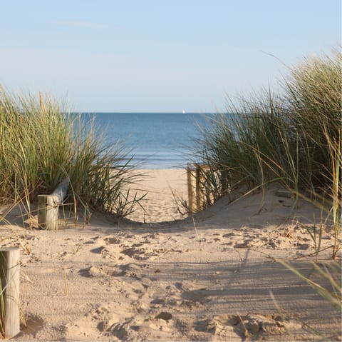 Sink your feet into the sand at Back beach, a five-minute walk away