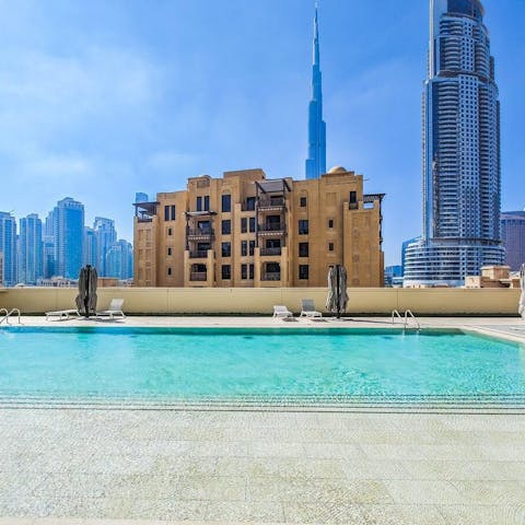 Swim in the communal pool as skyscrapers surround you