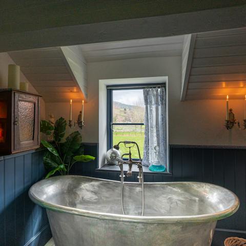 Treat yourself to a long soak in the antique zinc tub – a glass of bubbly in hand – while enjoying breathtaking natural scenery