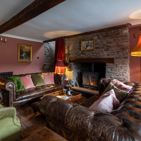 Spend cooler evenings snuggled up on the Chesterfield sofas next to the living room's roaring fire