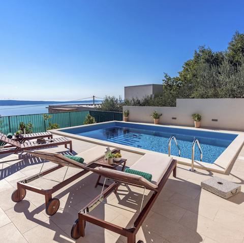 Spend gorgeous days relaxing by the pool, enjoying glittering sea views, and taking dips to cool off