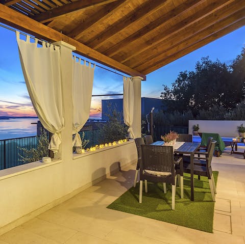 Gather around the dining table for alfresco barbecue dinners while taking in the wildly beautiful sunset views
