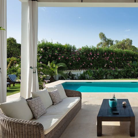 Relax by the poolside on the comfortable outdoor sofas