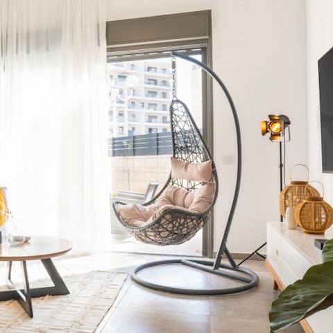 Get cosy on the swinging egg chair, the perfect spot for catching up on your book