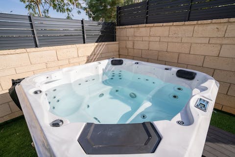 Relax in the bubbling hot tub, sipping on a nice glass of wine