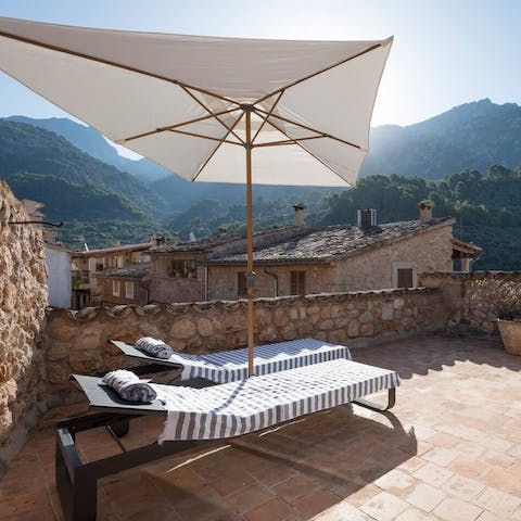 Catch a tan on the roof terrace surrounded by mountains