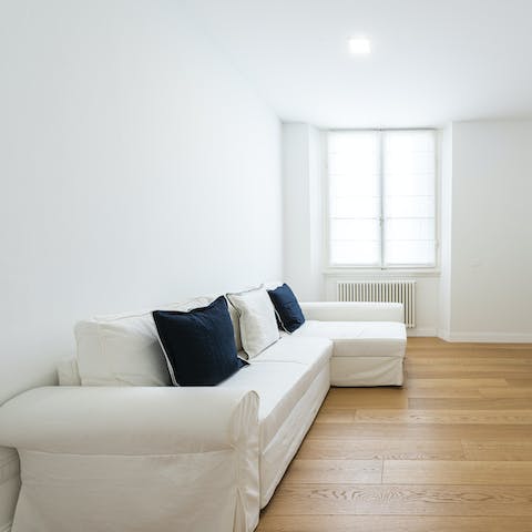 Relax in the minimalist living room with a glass of wine after a day of sightseeing