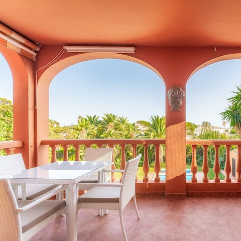 Enjoy dinner alfresco on the private balcony overlooking the lush landscape