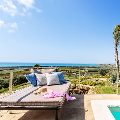 Lie back and enjoy the ocean views from the sumptuous sun beds