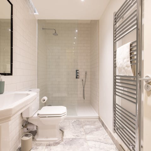 Start mornings with a luxurious soak beneath the metro-tiled bathroom's rainfall shower