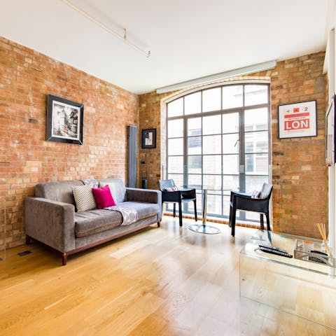 People-watch from the industrial-style living room's huge warehouse window