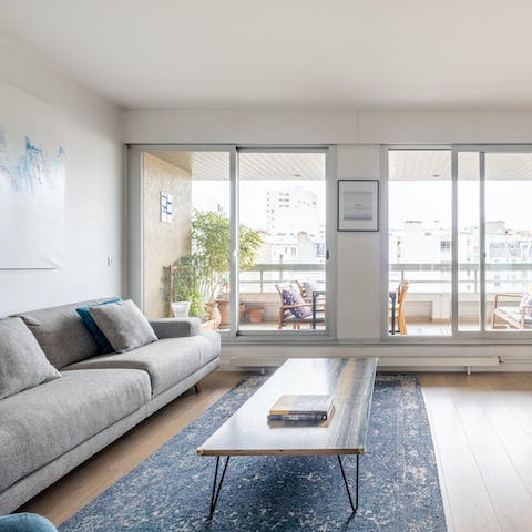 Relax in the bright living room with a glass of wine after a day of exploring