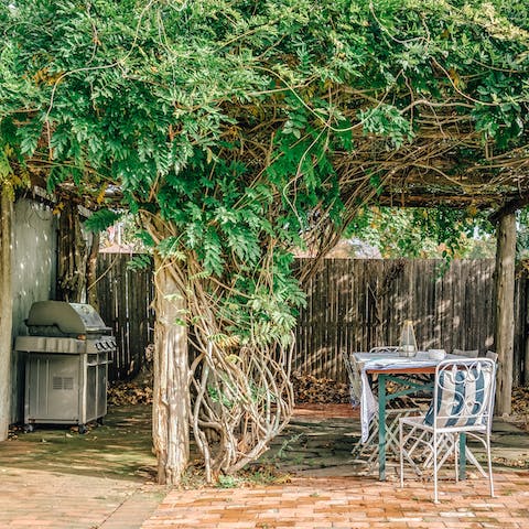 Fire up the barbecue and dine under the wisteria