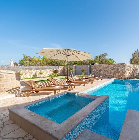 Swim in a heated pool with its own jacuzzi, water feature and sun deck