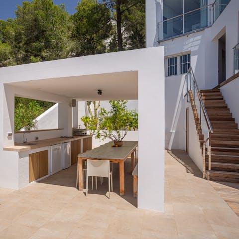 Prepare feasts in the outdoor kitchen and enjoy them under the shaded cabana