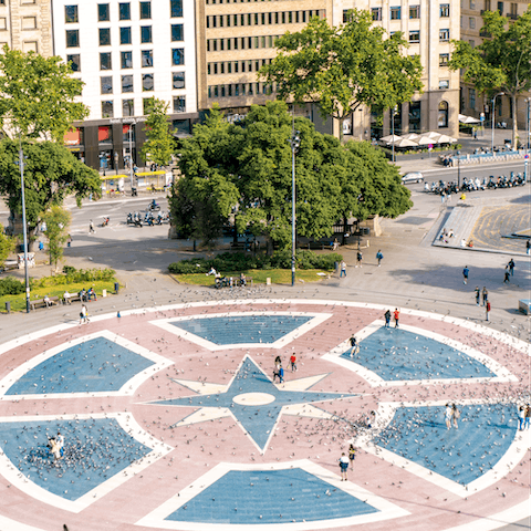 Stretch your legs with a gentle stroll across the Plaza Catalunya, only fifteen minutes away