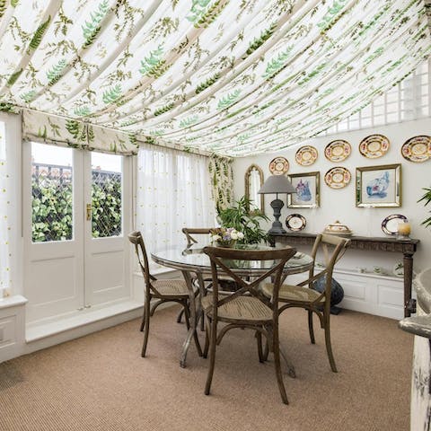 Gather around the conservatory dining table for memorable dinners
