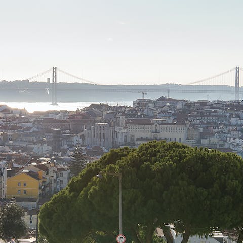 Admire the incredible city and River Tagus views from the private balcony