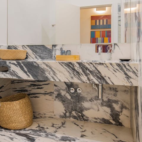 Get ready for a night out in the marble-clad bathroom