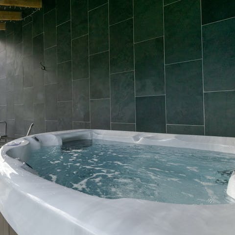 Sink into the bubbling hot tub after a long day of hiking and exploring, glass of bubbly in hand