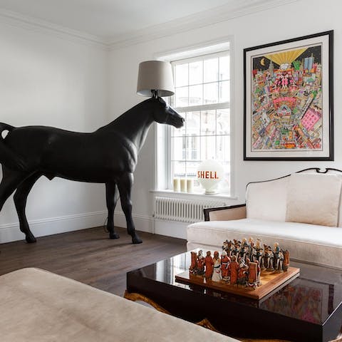 Play a game of chess in the living room while discussing the art collection