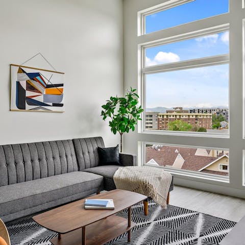 Kick back in the bright living room while admiring Denver vistas from the floor-to-ceiling windows