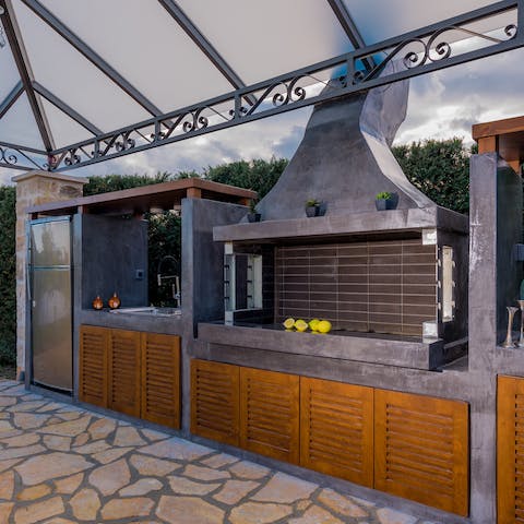 Go beyond the average summer barbecue in the full outdoor kitchen