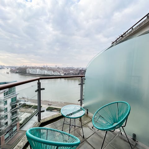 Admire the views over the river and London skyline from the private balcony