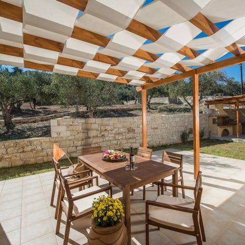 Sit down to an al fresco meal overlooking the olive trees