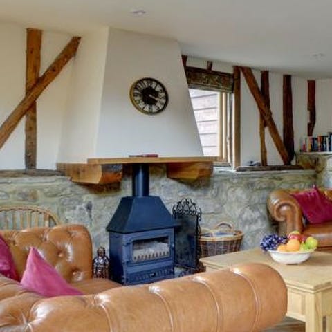 Relax in an armchair by the wood burner stove