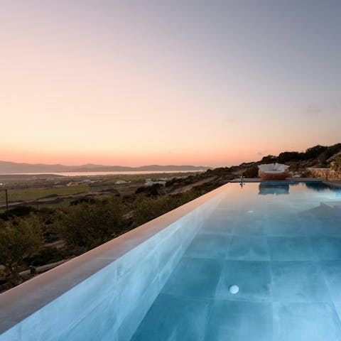 Slip into the pool for a swim at sunset