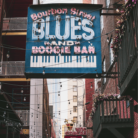 Follow the jazz beats down to Bourbon Street, just a ten-minute streetcar ride away