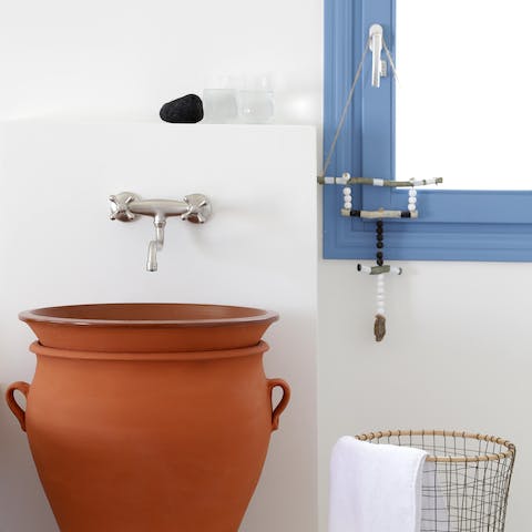 Fall in love with the small Grecian details, like the sink crafted from a clay pot