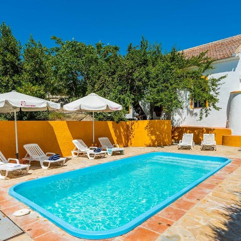 Jump into the shimmering swimming pool and dry off on a lounger