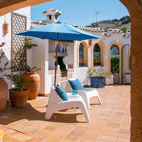 Catch the rays on your gorgeous patio, complete with sun umbrellas