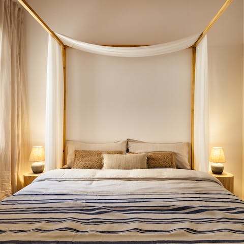 Enjoy a blissful night's sleep in the main bedroom's luxurious four-poster bed