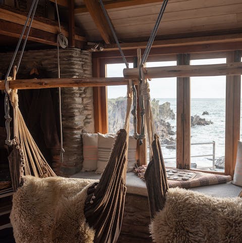 Curl up in a hanging hammock chair and watch the waves
